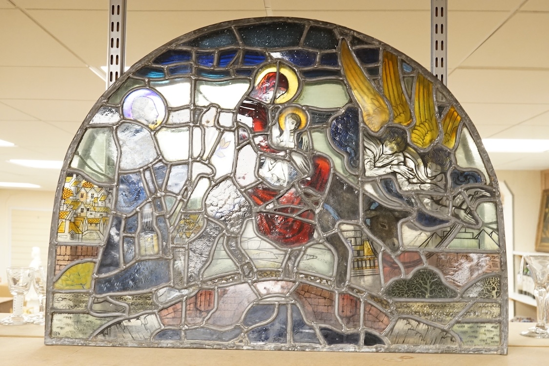 A 20th century semi circular stained glass panel, approximately 80cm wide